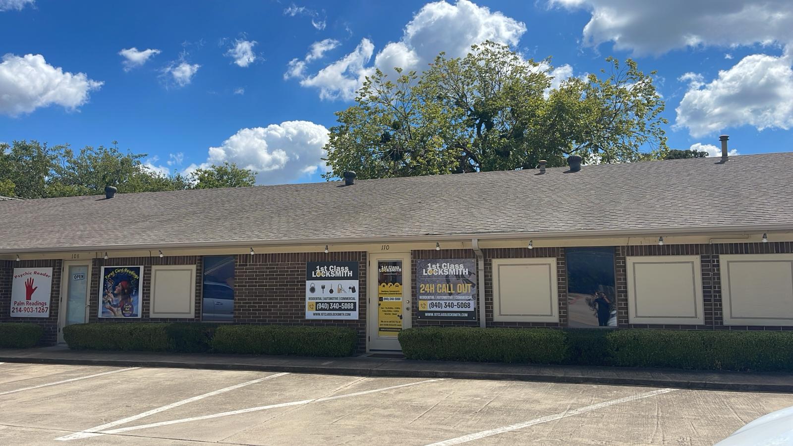 Business hours and contact details displayed on 1st Class Locksmith Denton's storefront door, serving Denton, TX, with expert locksmith services.